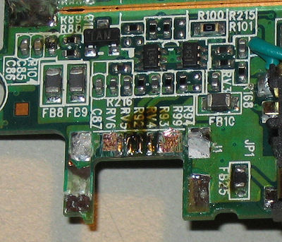 GPS circuit board with coating removed exposing power lands.