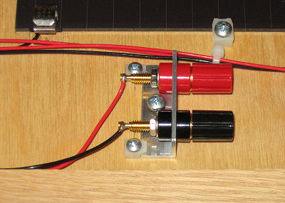 Closeup view of home built Solar Briefcase panel mounting and banana jacks power output.